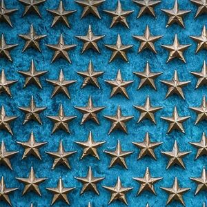 Gold Star Pattern on Blue Background